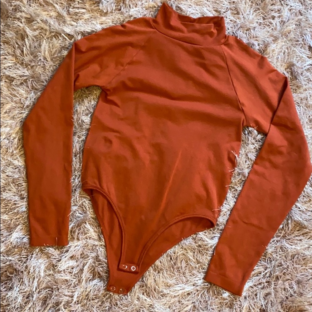 orange-red long sleeve turtle neck body suit